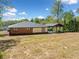 Spacious backyard showcasing the rear of the home and covered carport at 5017 Spring Hill Dr, Sugar Hill, GA 30518