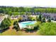 Aerial shot of a community pool surrounded by lush greenery and residential homes at 7154 Sw Chara Sw Ln, Atlanta, GA 30331