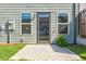 Home backyard showcasing a patio, well-kept lawn, and stylish home exterior at 7154 Sw Chara Sw Ln, Atlanta, GA 30331