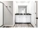 Bathroom with dual sinks, granite countertops, and a walk-in shower at 7154 Sw Chara Sw Ln, Atlanta, GA 30331