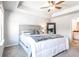 Cozy bedroom featuring a tray ceiling, plush carpet, and an ensuite bathroom offering both style and functionality at 7154 Sw Chara Sw Ln, Atlanta, GA 30331