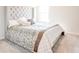 Comfortable bedroom featuring a tufted headboard and patterned bedding for a cozy retreat at 7154 Sw Chara Sw Ln, Atlanta, GA 30331
