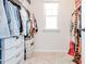 Walk-in closet with built-in shelves and ample storage space at 7154 Sw Chara Sw Ln, Atlanta, GA 30331