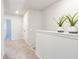 Upstairs hallway with carpet floors and plants offers access to all areas of the upper level at 7154 Sw Chara Sw Ln, Atlanta, GA 30331