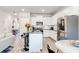 Modern kitchen with white cabinets, black countertops, stainless steel appliances, and an open floor plan at 7154 Sw Chara Sw Ln, Atlanta, GA 30331