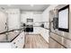 Bright kitchen with white cabinets, stainless steel appliances, and granite countertops at 7154 Sw Chara Sw Ln, Atlanta, GA 30331