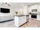 Open concept living area featuring a modern kitchen with an island and adjacent living room at 7154 Sw Chara Sw Ln, Atlanta, GA 30331