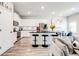 Open-concept kitchen with white cabinetry, stainless steel appliances, and an island with bar seating at 7154 Sw Chara Sw Ln, Atlanta, GA 30331