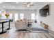 Open living area with contemporary furnishings, including a plush sofa and a large television at 7154 Sw Chara Sw Ln, Atlanta, GA 30331