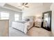 Bright main bedroom features a tray ceiling, soft carpet, and neutral decor at 7154 Sw Chara Sw Ln, Atlanta, GA 30331
