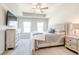 Bright main bedroom features a tray ceiling, soft carpet, and neutral decor with TV at 7154 Sw Chara Sw Ln, Atlanta, GA 30331