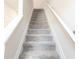 Carpeted staircase with white handrails leading to the next level of the home at 7154 Sw Chara Sw Ln, Atlanta, GA 30331