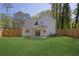 Spacious backyard with lush green lawn, fenced perimeter, and covered patio area at 1353 Midlawn Dr, Decatur, GA 30032