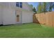 Fenced backyard with a door to the home's interior, and manicured lawn at 1353 Midlawn Dr, Decatur, GA 30032