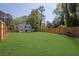Expansive backyard featuring a meticulously maintained lawn and a sturdy wooden fence at 1353 Midlawn Dr, Decatur, GA 30032