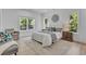 Sun-lit bedroom features a stylish rug, a decorative accent chair, and nature views at 1353 Midlawn Dr, Decatur, GA 30032