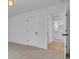 Clean bedroom featuring neutral carpet, white walls, and an open door to a well-lit bathroom at 1353 Midlawn Dr, Decatur, GA 30032