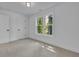 Inviting bedroom featuring neutral carpet, large window with green views, and crisp white trim at 1353 Midlawn Dr, Decatur, GA 30032