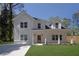 Beautiful two-story home with white siding, a welcoming front porch, and a well-maintained green lawn at 1353 Midlawn Dr, Decatur, GA 30032