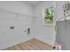Neat laundry room with new flooring, water heater, and wire rack shelving at 1353 Midlawn Dr, Decatur, GA 30032