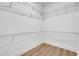 Bright walk-in closet with white walls, light wood floors, and sturdy wire shelving at 1353 Midlawn Dr, Decatur, GA 30032