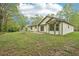Lush backyard with lawn and patio, the perfect place to relax and enjoy the outdoors, surrounded by mature trees at 3719 Bomar Rd, Douglasville, GA 30135