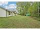 Expansive backyard with ample lawn space, lush trees, and an outdoor storage shed for gardening equipment and tools at 3719 Bomar Rd, Douglasville, GA 30135