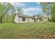 Spacious backyard featuring a well-maintained lawn and the rear of the house, all surrounded by lush greenery at 3719 Bomar Rd, Douglasville, GA 30135