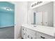 Bright bathroom vanity with white cabinets, marble countertop, undermount sink, and large mirror at 3719 Bomar Rd, Douglasville, GA 30135
