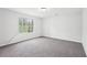 This bedroom has gray walls, carpet flooring, and a window at 3719 Bomar Rd, Douglasville, GA 30135