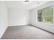 This bedroom has gray walls, carpet flooring, and a window at 3719 Bomar Rd, Douglasville, GA 30135