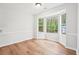 Inviting dining room with chair rail, hardwood floors, and a bright bay window overlooking lush greenery at 3719 Bomar Rd, Douglasville, GA 30135