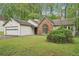 Single-story home with attached garage, brick accent window, and mature landscaping at 3719 Bomar Rd, Douglasville, GA 30135