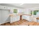 Charming kitchen features white cabinets, wood countertops, and stainless steel sink under a large window at 3719 Bomar Rd, Douglasville, GA 30135