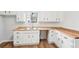 Charming kitchen features white cabinets, wood countertops, and stainless steel sink under a large window at 3719 Bomar Rd, Douglasville, GA 30135