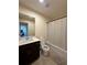 Modern bathroom features a vanity, sink, toilet, shower with curtain and neutral-colored tile flooring at 4215 Almanor Cir, Norcross, GA 30071
