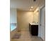 Bright bathroom featuring a double vanity, large mirror, soaking tub, and neutral tile flooring at 4215 Almanor Cir, Norcross, GA 30071