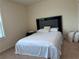 Cozy bedroom with natural light, plush carpet, and a bed with a decorative headboard and soft linens at 4215 Almanor Cir, Norcross, GA 30071
