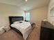 Serene bedroom with natural light, plush carpet, a bed with a stylish headboard, and soft bedding at 4215 Almanor Cir, Norcross, GA 30071