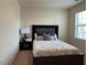 Comfortable bedroom featuring carpet, a bed with a large headboard, and natural light from a window at 4215 Almanor Cir, Norcross, GA 30071