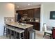 Kitchen featuring dark cabinets, granite countertops, stainless steel appliances, and a breakfast bar at 4215 Almanor Cir, Norcross, GA 30071