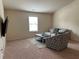 Inviting living room featuring carpet, comfortable seating, a modern coffee table, and a window for natural light at 4215 Almanor Cir, Norcross, GA 30071