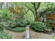 Beautiful backyard with a sundial, lush greenery, and brick home exterior at 5884 Hammersmith Rd, Stone Mountain, GA 30087