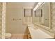 Bright bathroom with floral wallpaper, white vanity, and natural light from the window at 5884 Hammersmith Rd, Stone Mountain, GA 30087