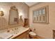 Charming powder room featuring floral wallpaper, decorative mirror, vanity, and window with shutters at 5884 Hammersmith Rd, Stone Mountain, GA 30087