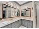 Bathroom with double vanity sinks, marble countertops and tile floor at 5884 Hammersmith Rd, Stone Mountain, GA 30087