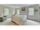 Cozy bedroom with white bedding, two large windows, and a sitting area at 5884 Hammersmith Rd, Stone Mountain, GA 30087