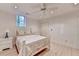 Well-lit bedroom with white furniture, ceiling fan, and bright window at 5884 Hammersmith Rd, Stone Mountain, GA 30087