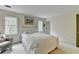 Comfortable bedroom featuring a queen bed, natural light, and neutral decor at 5884 Hammersmith Rd, Stone Mountain, GA 30087