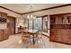 Cozy dining area featuring a wooden table, Windsor-style chairs, and large windows overlooking a wooded area at 5884 Hammersmith Rd, Stone Mountain, GA 30087